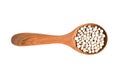 White peppercorns in wooden spoon