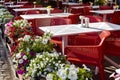 white perforated tables with red chairs of an outdoor cafe. Royalty Free Stock Photo