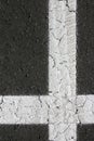 White perpendicular shaped cross on black asphalt