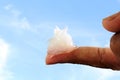 White petroleum jelly on finger in sky background Royalty Free Stock Photo