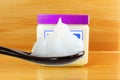White petroleum jelly in spoon with jar