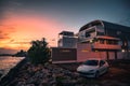 White Peugeot parked by the waterside modern house at sunset in Guadeloupe