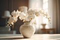 White Phalaenopsis orchid in a beautiful vase on a table in a classic interior.