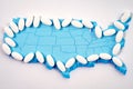 White pharmaceutical pills over map of America background Royalty Free Stock Photo