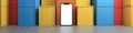 A white phone is sitting on a floor in front of a stack of colorful boxes Royalty Free Stock Photo