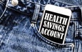 White phone with text Health Savings Account lies in jeans pocket