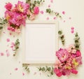 White photo frame and bouquets of pink flowers