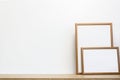 White photo frames on a wooden table. Royalty Free Stock Photo
