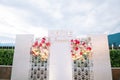 White photo zone stand with colorful bouquets of flowers. Caption: Love forever