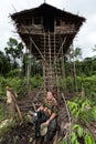 White photographer at Korowai people House Royalty Free Stock Photo