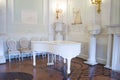 White piano in the hall. The interior of the Palace.