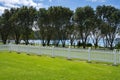 White picket fence across green lawn