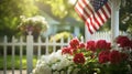 A white picket fence with flowers and an american flag Royalty Free Stock Photo