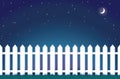 White picket fence at night