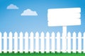 White picket fence with a sign