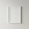 White picture frame hangs on a plain, textured wall. The frame is rectangular, featuring Royalty Free Stock Photo