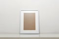 white picture frame on a table. Stylish photoframe with passe-partout for poster or picture Royalty Free Stock Photo