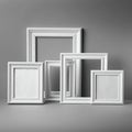 White picture frames of varying sizes are arranged against a neutral gray background. Royalty Free Stock Photo