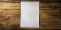 A white piece of paper sits on a wooden surface, copy space