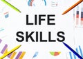 White piece of paper with text Life Skills on the background of the graphs, multi-colored felt-tip pens