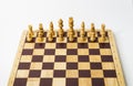 White pieces - chess board on white background in studio