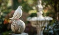 White pigeon perched on a marble statue with a peace globe in the background in a serene garden setting Royalty Free Stock Photo