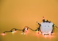 White piggy bank with Christmas string lights on happy December festival, Enjoy savings for spending money on the holiday`s Royalty Free Stock Photo