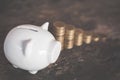 White piggy bank and coin on wood Royalty Free Stock Photo