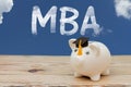 A white piggy bank with grad cap on weathered wood with sky back Royalty Free Stock Photo