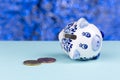 White piggy bank on its side blue background