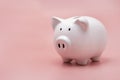 White piggy bank for money saving isolated on pastel pink background with copy space Royalty Free Stock Photo