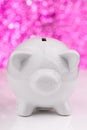 White piggy bank on pink background