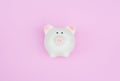 White piggy bank on pink pastel background with copy space as debt or financial problem solution, saving money Royalty Free Stock Photo