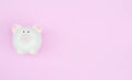 White piggy bank on pink pastel background with copy space as debt or financial problem solution, saving money Royalty Free Stock Photo