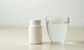 White pill bottle and glass of water Royalty Free Stock Photo