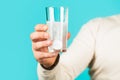 White pill and a glass of water in man hands. Health concept. Close up of man holding a pill. Glass of water tablet Royalty Free Stock Photo