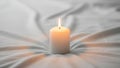 White pillar candle with a bright flame is placed on a soft white Royalty Free Stock Photo