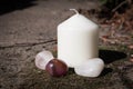 White Pillar candle with small collection of crystal tumbled gem stones