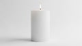 A white pillar candle stands on a plain surface against a matching background Royalty Free Stock Photo