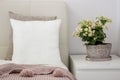 White pillow on bed in a cozy bedroom, Mockup