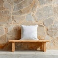 White pillow on a wooden bench against a stone wall in a bright and minimalist interior setting Royalty Free Stock Photo