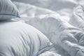 White pillows and blanket. Wrinkle messy blanket in bedroom after waking up in the morning. Bed details. Royalty Free Stock Photo