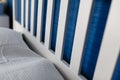 With white pillows and white linens on the white large wooden double bed in the bedroom against the blue wall. White pillows on th Royalty Free Stock Photo