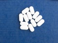 White pills on a blue background