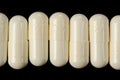 White Pills (Capsules) on Black Background Royalty Free Stock Photo