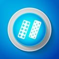 White Pills or capsules in blister package icon isolated on blue background. Tablets in package. Medications Accessory Royalty Free Stock Photo