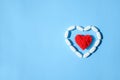 White pills capsules and red thread heart shape on blue backgrou Royalty Free Stock Photo