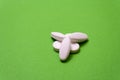 White pills, drugs on green background isolated Royalty Free Stock Photo