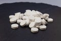 White pills, drugs on grey background. Prevention of coronavirus. Web banner on site with empty space for text on the left side.