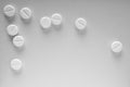 White pills lie on a sheet of gray paper. Close up. Light background or backdrop on the theme of medicine, health care, drugs, Royalty Free Stock Photo